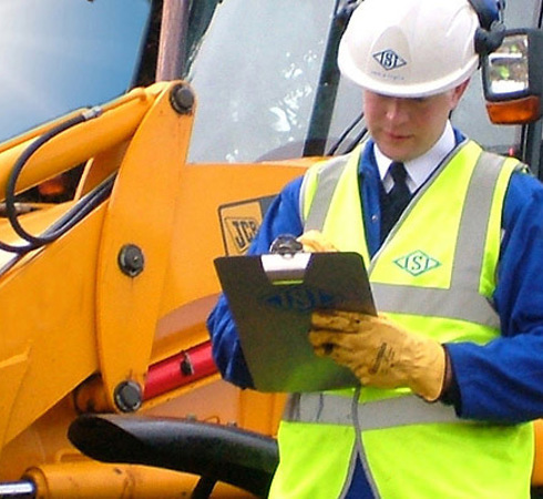 Construction worker standing next to a machine