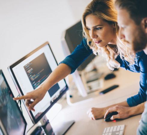 Office workers, working on a computer together