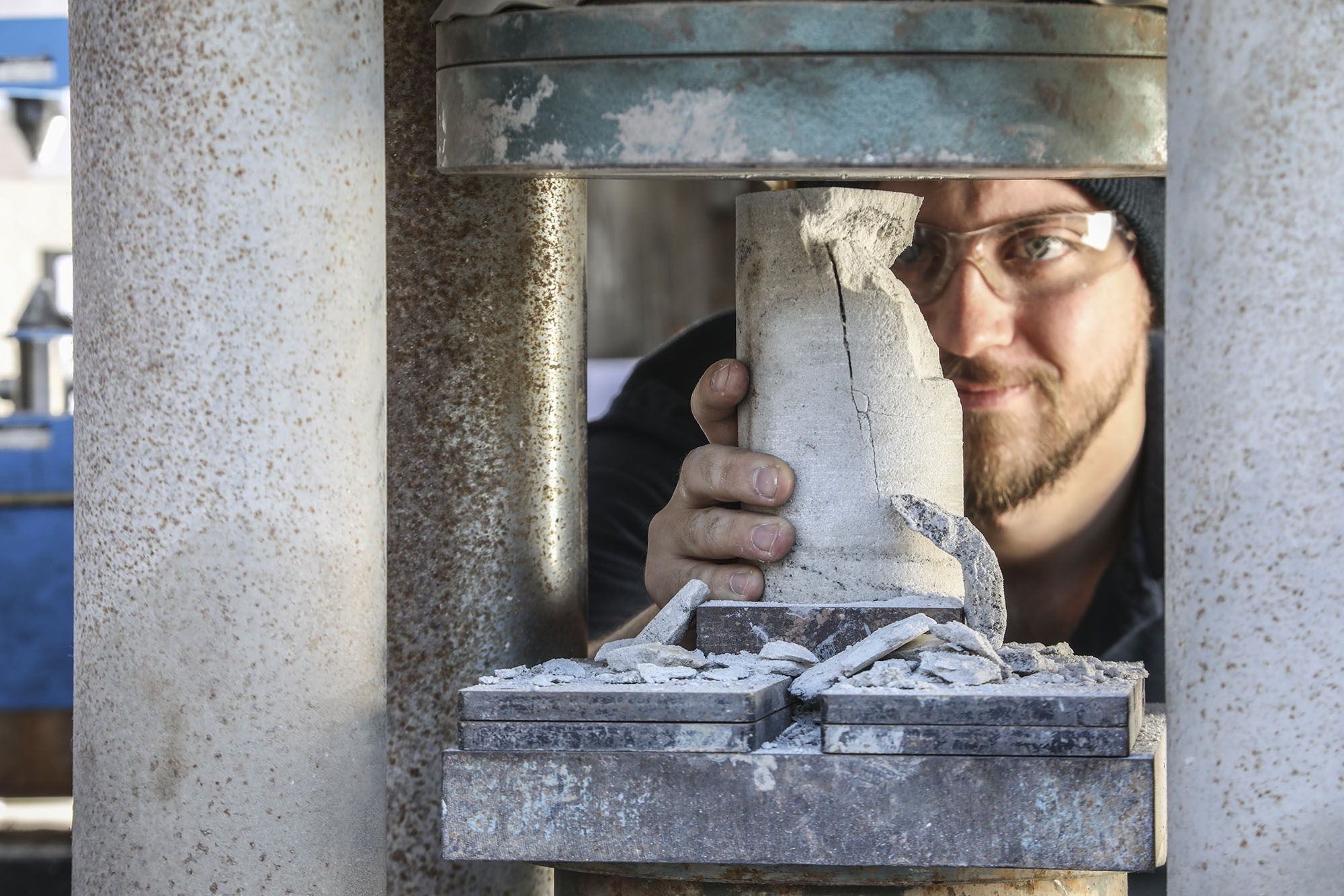 A Lab Technician undertaking an Unconfined Compression Test